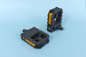folding bicycle pedals, part of a folding bicycle, isolated on blue background photo