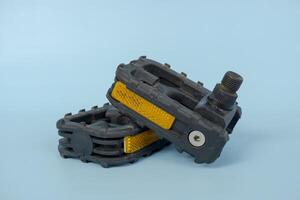 folding bicycle pedals, part of a folding bicycle, isolated on blue background photo