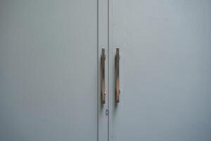 The door handle of an office is in the middle of a minimalist background photo