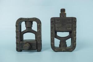 folding bicycle pedals, part of a folding bicycle, isolated on blue background photo