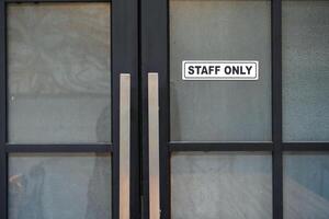 Warning sign on front door with message for staff only photo