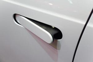 close up of modern car door handle without keyhole or keyless photo