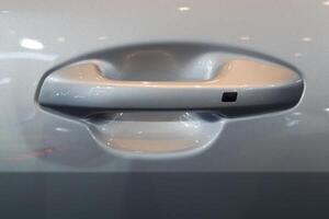 close up of modern car door handle without keyhole or keyless photo