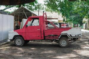 an old pick up truck painted in red and white in a rustic and classic style photo