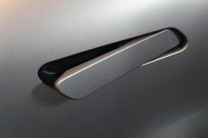 close up of modern car door handle without keyhole or keyless photo