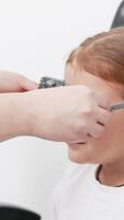 A doctor diagnosing a little girl vision and selecting lenses using a modern medical device. Perfect for illustrating diagnostics and vision correction video