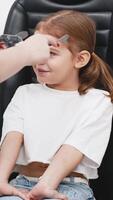 A doctor diagnosing a little girl vision and selecting lenses using a modern medical device. Perfect for illustrating diagnostics and vision correction video