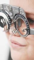 A doctor diagnosing a little girl vision and selecting lenses using a modern medical device. Perfect for illustrating diagnostics and vision correction video