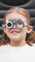 A doctor diagnosing a little girl vision and selecting lenses using a modern medical device. Perfect for illustrating diagnostics and vision correction video