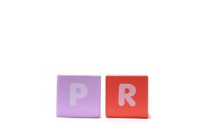text PR Public Relations on colorful wooden isolated on a white background photo
