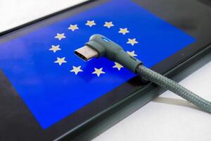 European Union flag and USB Type c charger The only USB type C charger approved in the plenary session of the European Parliament. photo