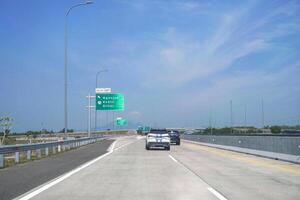 toll road at the exit intersection with direction signs to Nganjuk, Kediri and Blitar photo