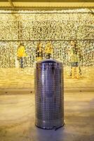 trash can with a bokeh background of LED lights at night at a carnival event photo