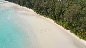 Aerial View Of The Text 'SUBSCRIBE' Written On White Sandy Tropical Beach. video