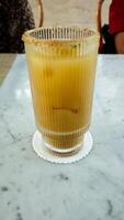 Refreshing Citrus Mocktail with Brown Sugar Rim on Marble Table with Lime Slice Topping photo