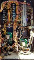 Close-up View of Colorful Electrical Wiring and Circuit Components Inside a Terminal Box in Bright Daylight photo