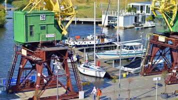 Szczecin, Poland. 14 September 2024. Landscape view and ships on the Odra river and old cranes photo