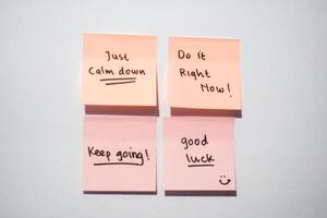 Just calm down, keep going, good luck on sticky notes. Motivational for personal development, inspirational handwriting. Isolated background photo
