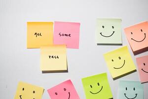 get some rest and smile emoticon on sticky notes. Motivational words for personal development, inspirational handwriting. Isolated on background photo
