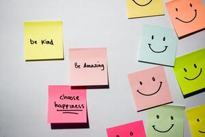 Be kind, Be Amazing, Choose happiness with smile emoticon on sticky notes. Motivational for personal development, inspirational handwriting. Isolated background photo