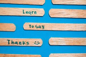stick of ice cream with the words Learn to say Thanks. Motivational quotes, optimism, positive words. Isolated on background photo