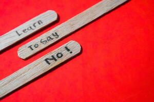 stick of ice cream with the words Learn to say No. Motivational quotes, optimism, positive words. Isolated on background photo
