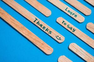 stick of ice cream with the words Learn to say Thanks. Motivational quotes, optimism, positive words. Isolated on background photo