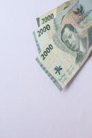 Indonesian money 2000 rupiah in close up photo from top corner