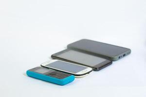 Mobile phones neatly arranged in a row and photographed from a side angle photo