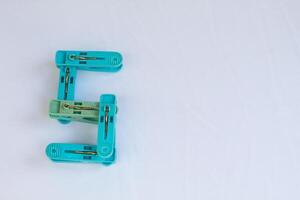 clothespin letter s photographed close up from a side angle with isolated background photo