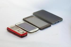 Mobile phones neatly arranged in a row and photographed from a side angle photo