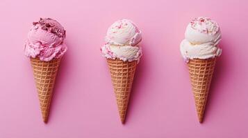 Three ice cream cones on a pink background photo
