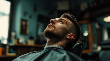 A man is sitting in a barber chair with his head up photo