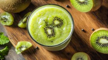 Kiwi smoothie with fresh kiwi fruit on wooden table photo