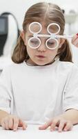 Diagnosis and improvement of vision in modern ophthalmology in young patients. The girl playfully engages in prevention, emphasizing the importance of a comfortable approach to treatment. video