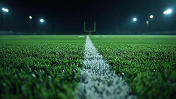 Football Field at Night with Illuminated Goalposts and Fresh Green Turf Under Stadium Lights photo