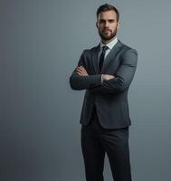 Professional Businessman in Suit Posing with Arms Crossed on Isolated Gray Background photo