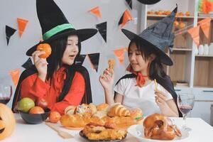 friendship, holiday and people concept - group of happy smiling friends in halloween costumes of vampire, devil, witch and cheetah at home party photo