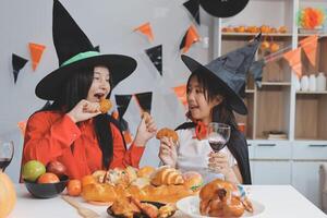 friendship, holiday and people concept - group of happy smiling friends in halloween costumes of vampire, devil, witch and cheetah at home party photo