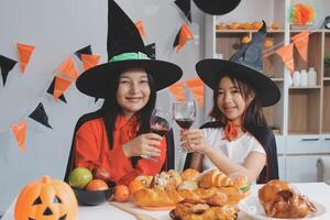 friendship, holiday and people concept - group of happy smiling friends in halloween costumes of vampire, devil, witch and cheetah at home party photo