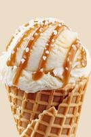 Delicious close-up of salted caramel ice cream in a waffle cone with caramel drizzle and sea salt sprinkles photo