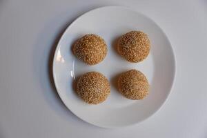 Close up of jian dui or sesame ball, a fried Chinese pastry made from glutinous rice flour on white background photo