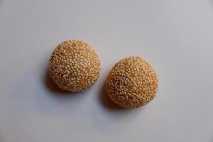 Close up of jian dui or sesame ball, a fried Chinese pastry made from glutinous rice flour on white background photo