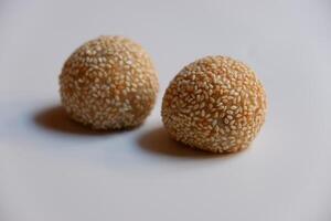 Close up of jian dui or sesame ball, a fried Chinese pastry made from glutinous rice flour on white background photo
