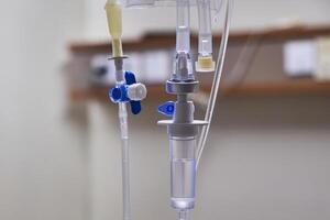 Close-up of slow iv fluid intravenous drip saline with blurred background in a hospital room, medical concept with copy space photo