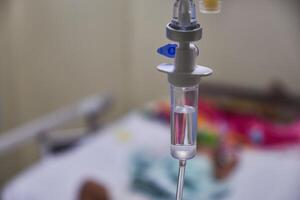 Close-up of slow iv fluid intravenous drip saline with blurred background in a hospital room, medical concept with copy space photo