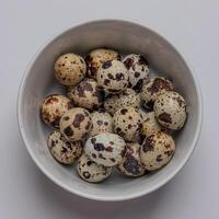 Top View of Quail eggs in a bowl isolated on white background photo