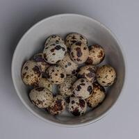 Top View of Quail eggs in a bowl isolated on white background photo