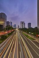 Traffic conditions in main road of Jakarta business center with office buildings photo