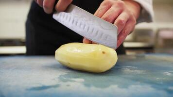 Chef Helper is Cutting Potatoes for Baking in Italian Restaurant Kitchen video